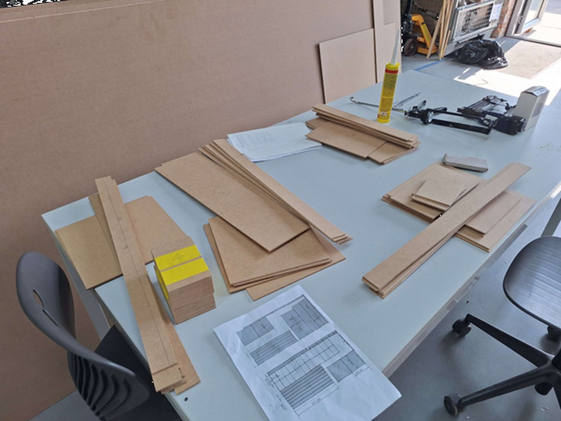 Laser-cut wooden parts and materials, laid out for assembly
